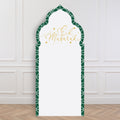 Decorative arch backdrop with 'Eid Mubarak' text on a white wall.