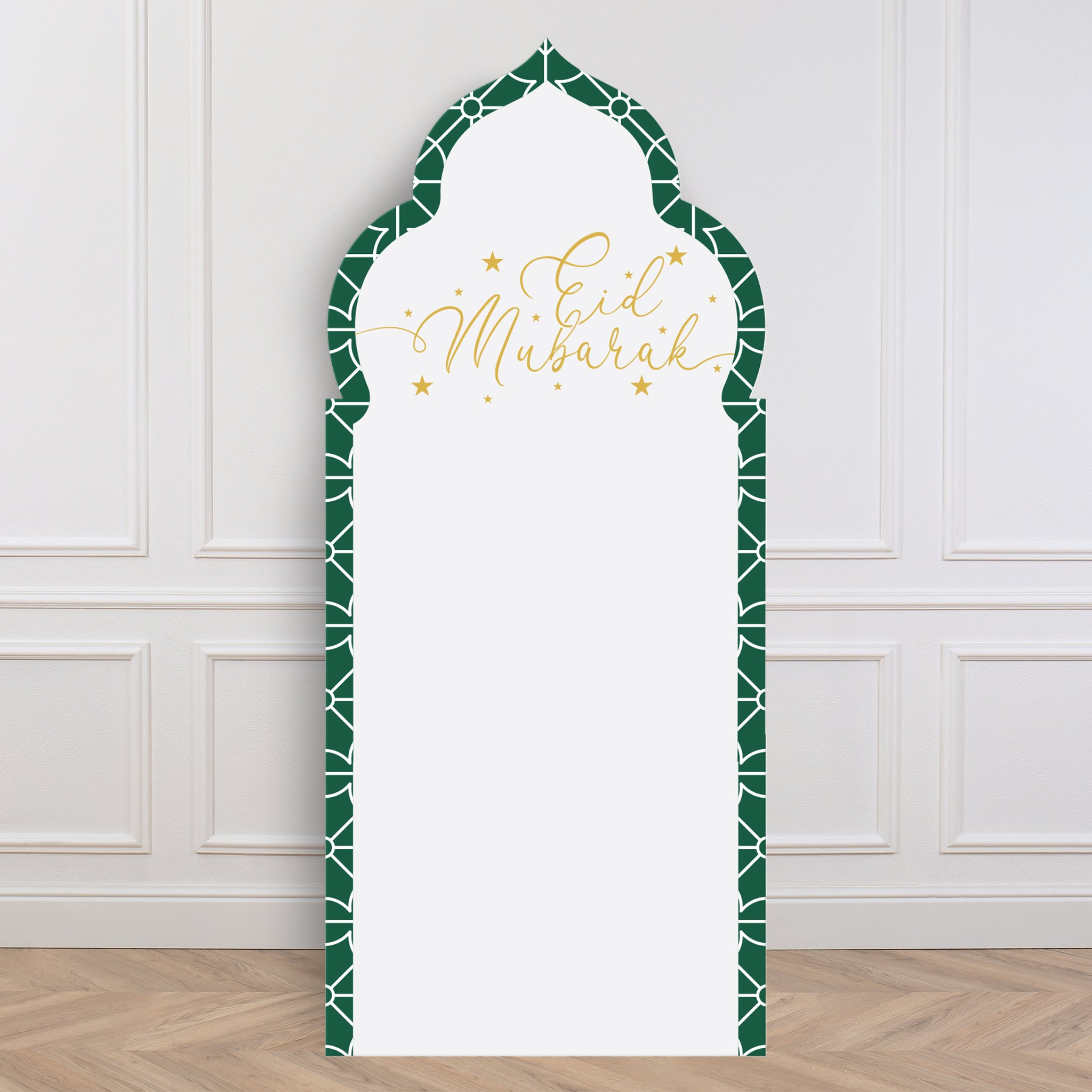 Decorative arch backdrop with 'Eid Mubarak' text on a white wall.