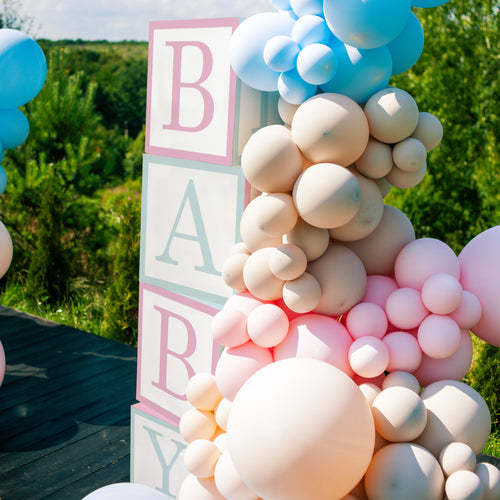 Balloon arch with 'BABY' cubes outdoors
