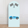 Light blue backdrop sailboard with a race car and checkered flags design on a white paneled wall.
