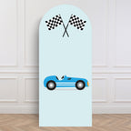 Light blue backdrop sailboard with a race car and checkered flags design on a white paneled wall.